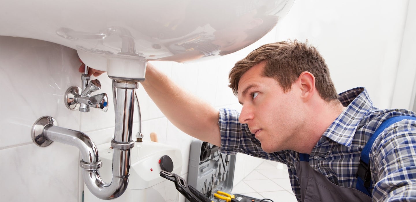 plumber fixing sink