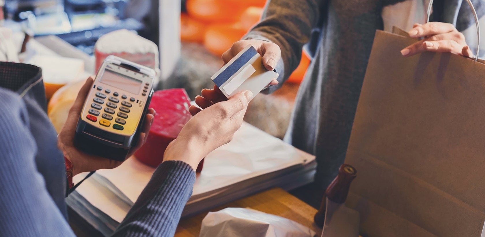 customer handing credit card to cashier