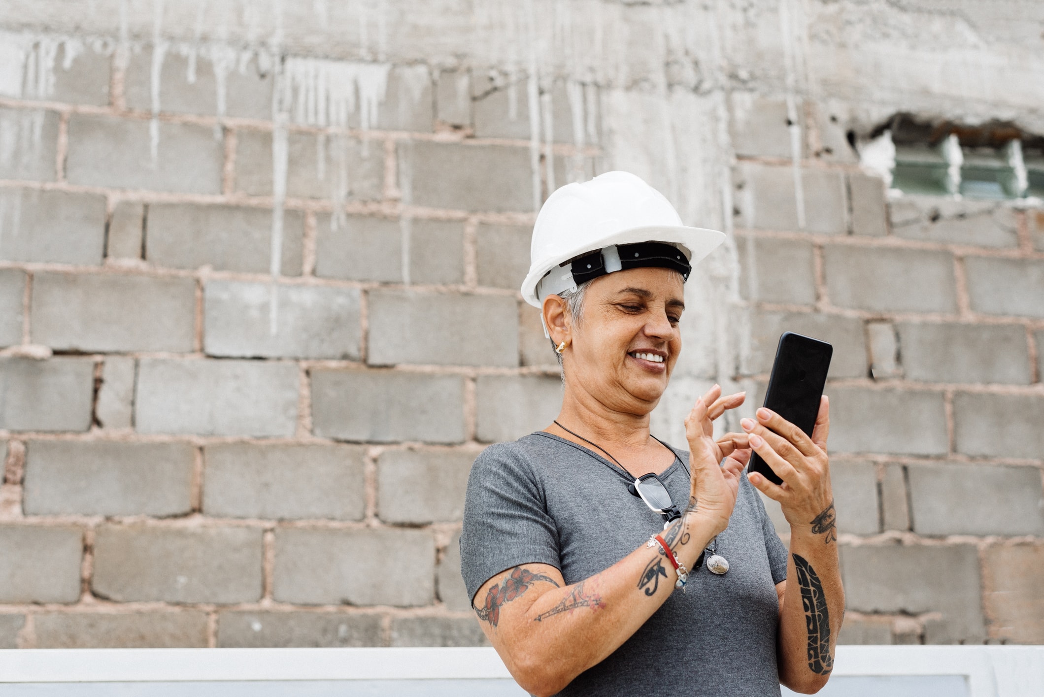 Female engineer using smartphone at construction.