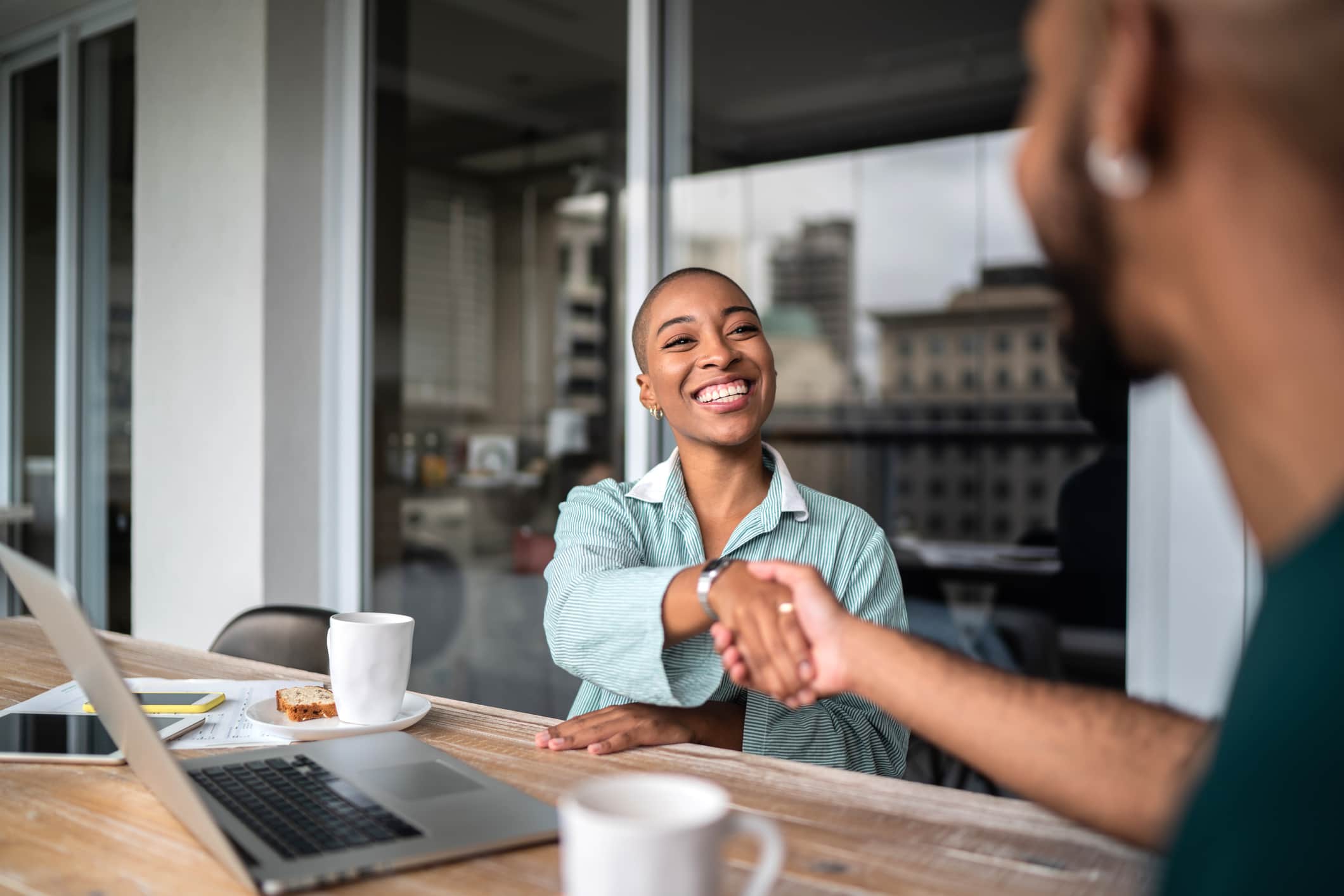 Financial advisor shaking hands with customer.