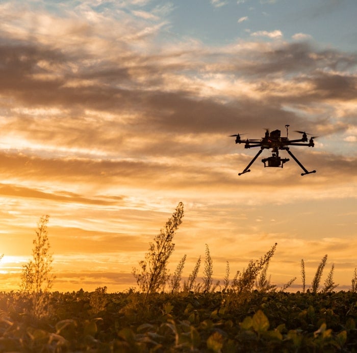 Drone flying off into sunset