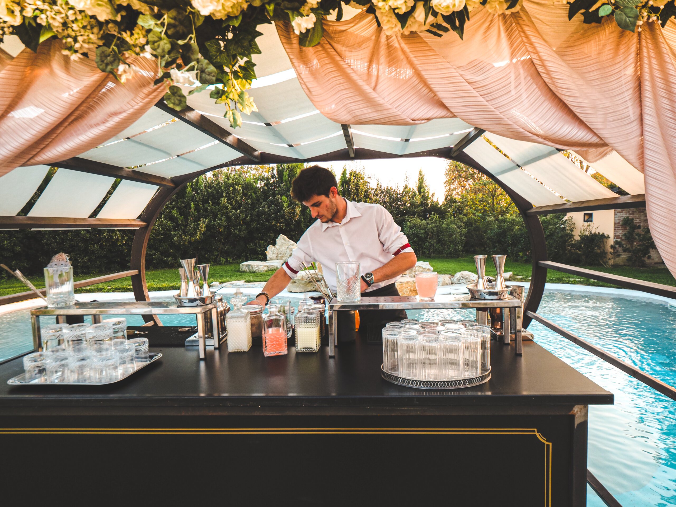 A professional barman at the Cocktail Bar decorated for the outdoor pool party