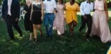 Group celebrating a wedding on a lawn