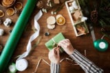 Close up shot of decorating a present for Christmas